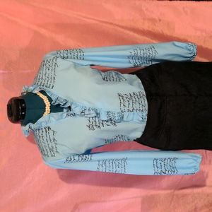 RUFFLED NEWSPAPER PRINT BABY BLUE BLOUSE